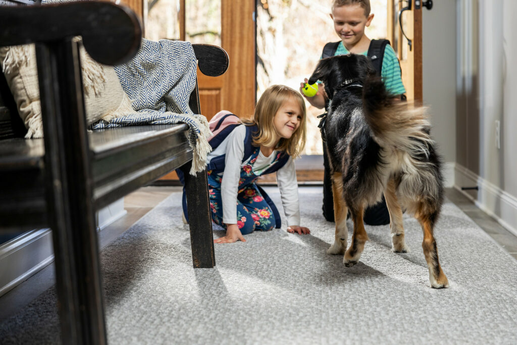 Kids playing with dog | Bud Polley's Floor Center